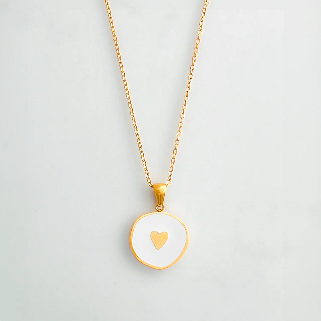 18K gold plated pendant necklace with white enamel center and a small gold heart in the middle.