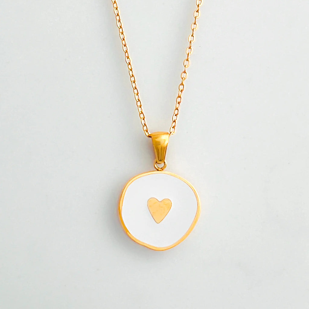 18K gold plated pendant necklace with white enamel center and a small gold heart in the middle.