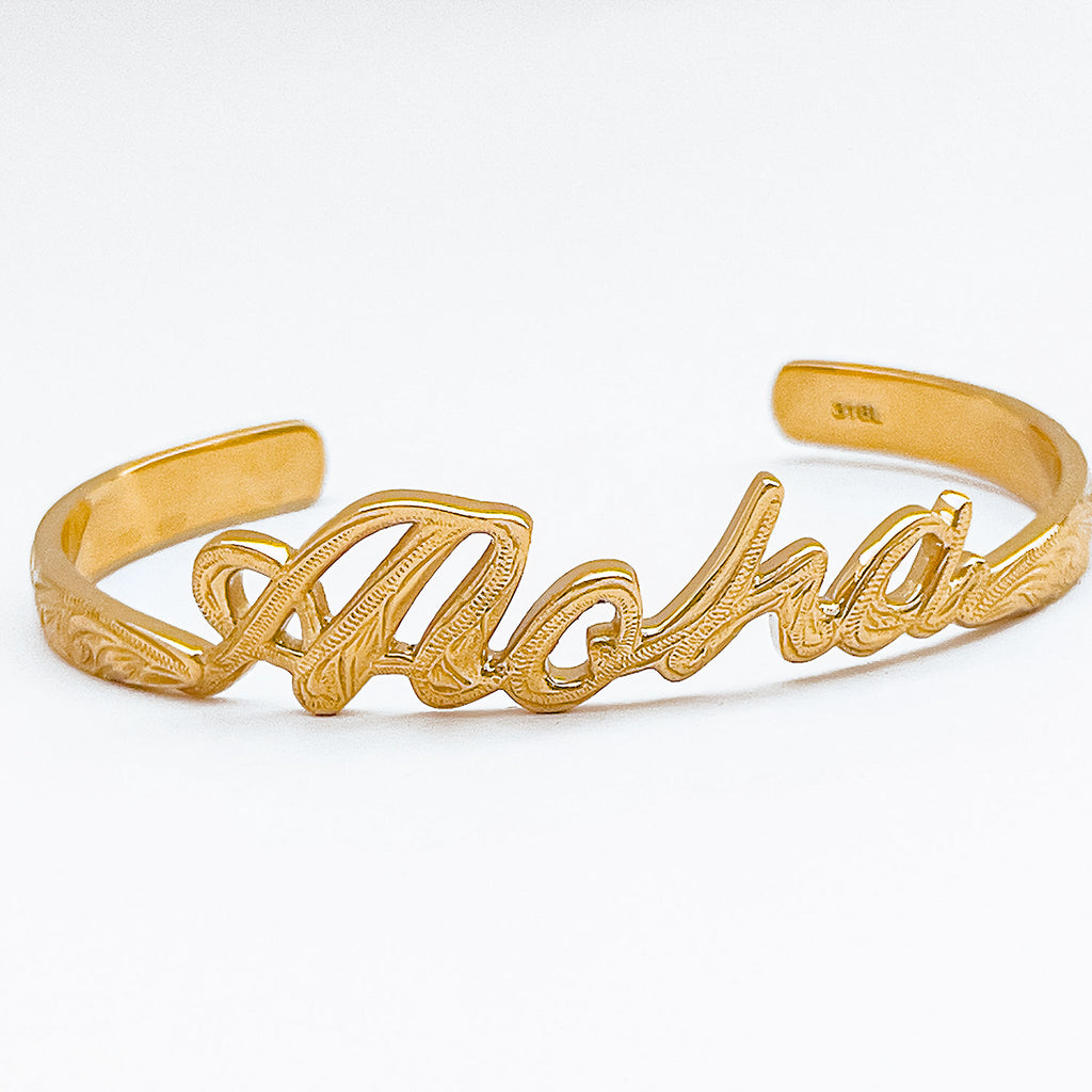 Gold-plated stainless steel  bangle, cuff style bracelet carved script Aloha with engraved design motif