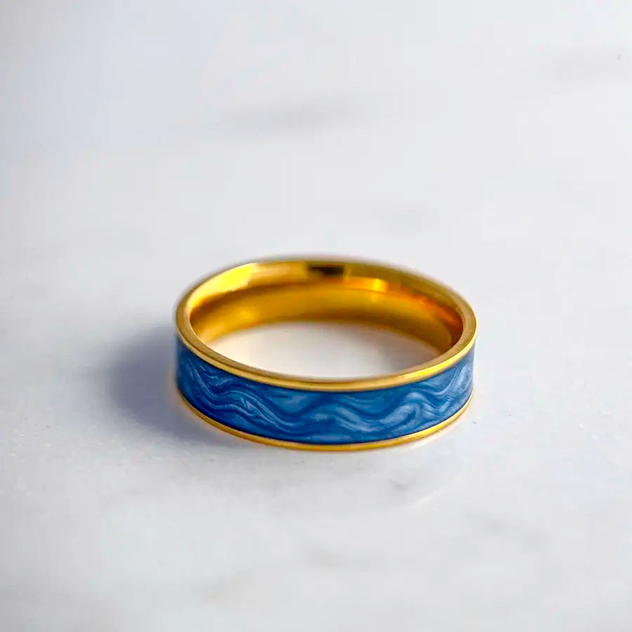 18k gold plated ring with a marbled blue enamel center.