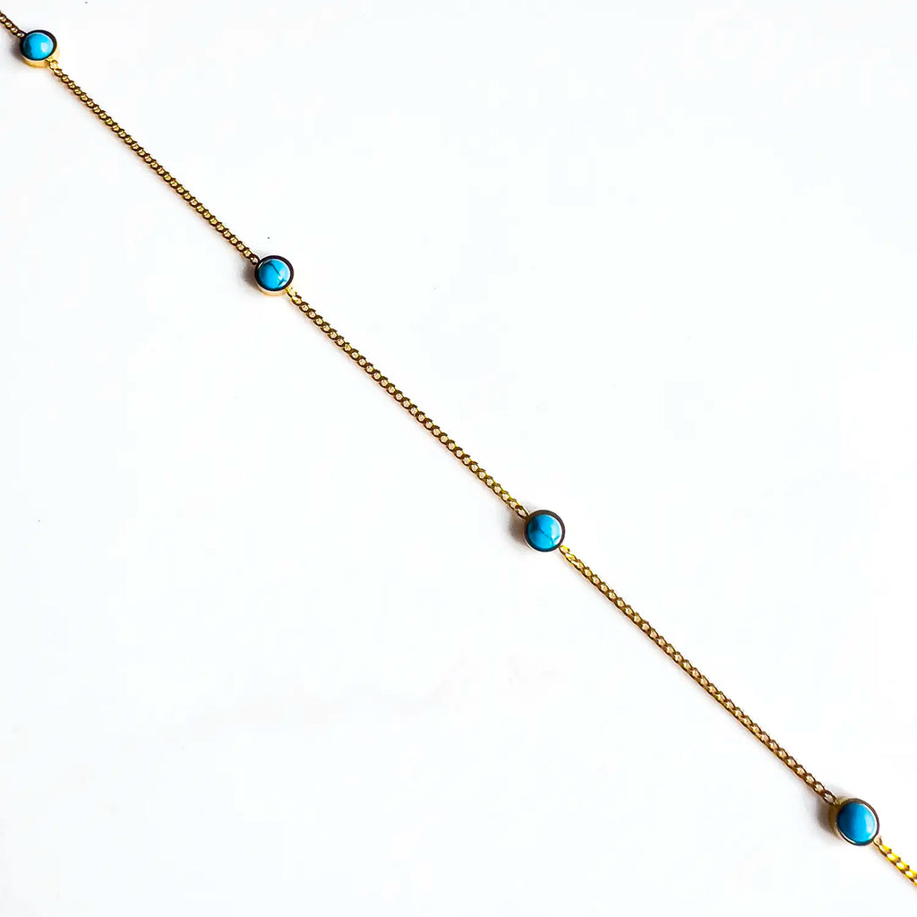 18k thin gold chain with natural turquoise stone beads spaced evenly along the chain.