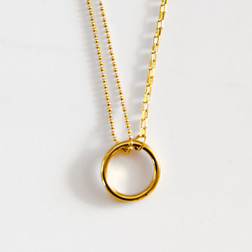 18k gold plated split chain necklace with "O" circle pendant connecting chains. One side of the chain is small circle beads and the other side is a typical chain-link style chain.