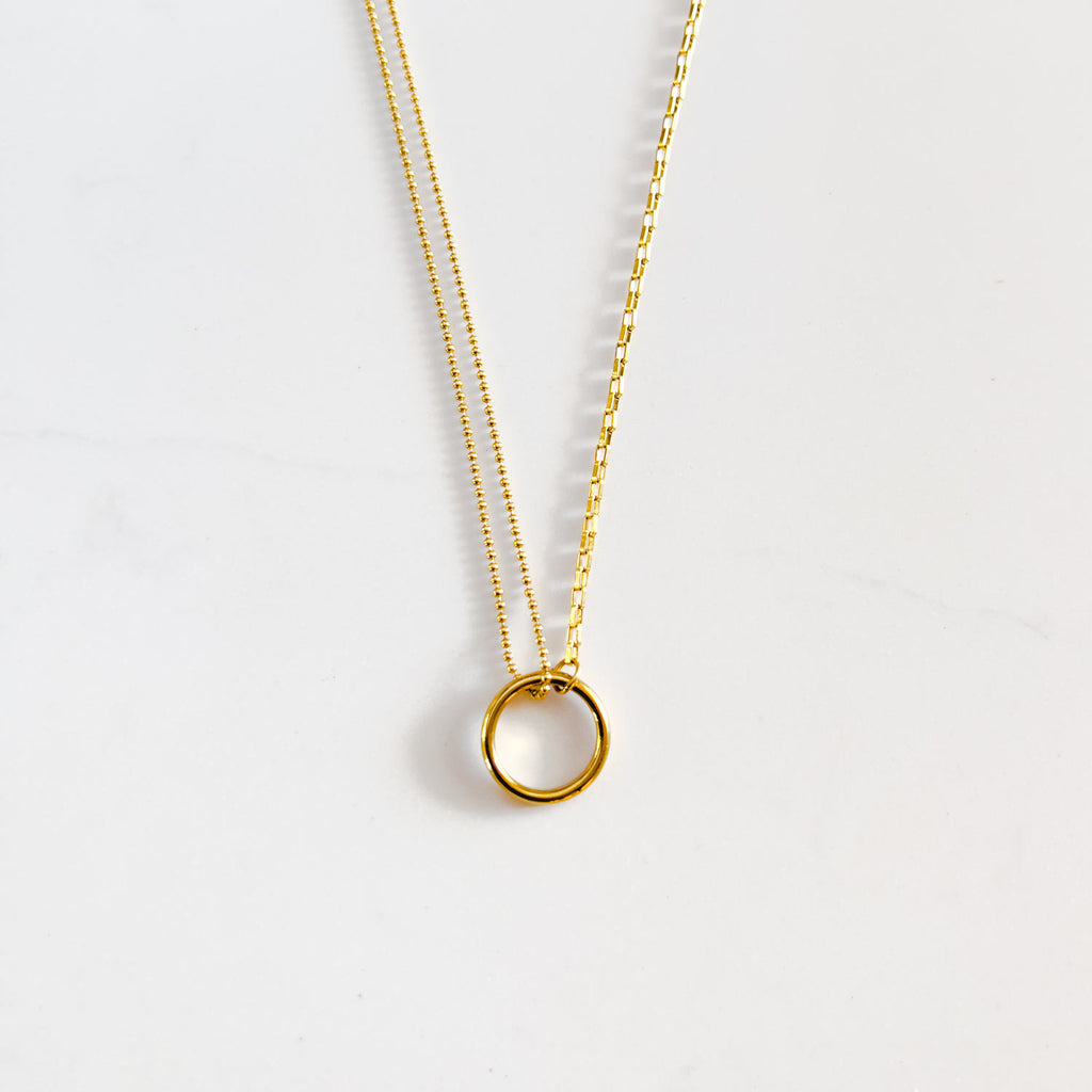 18k gold plated split chain necklace with "O" circle pendant connecting chains. One side of the chain is small circle beads and the other side is a typical chain-link style chain.