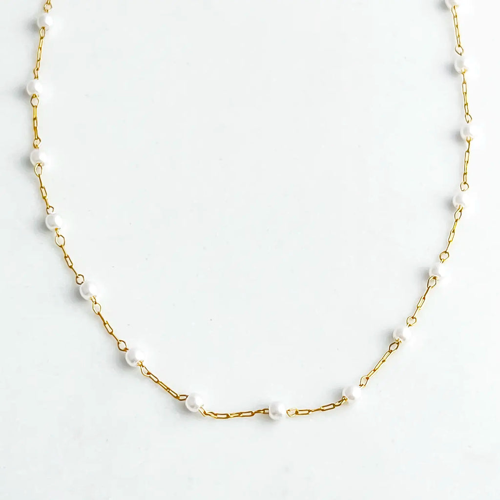 18k gold plated chain with faux pearl beads evenly spaced along chain. Chain has normal length and longer chain extender