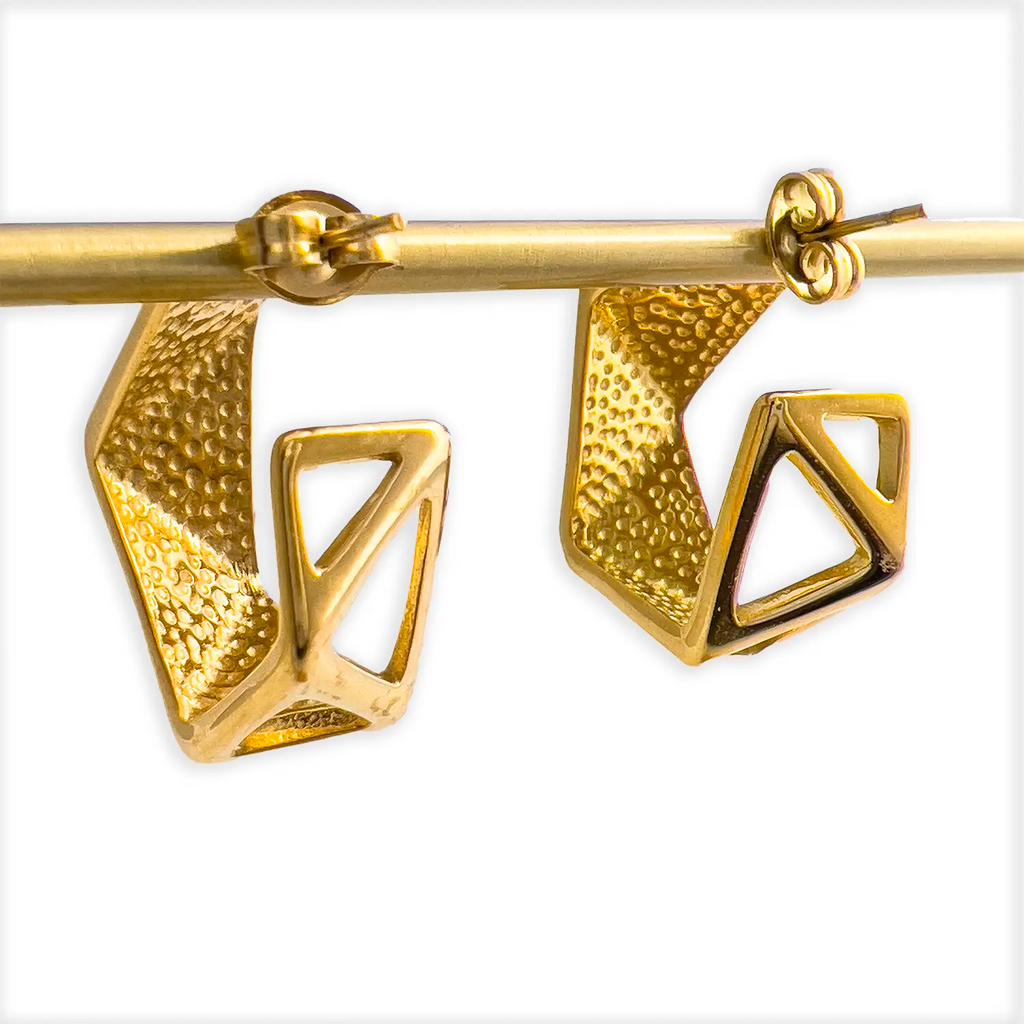 18k gold plated, geometric huggie earrings with blue/green enamel. Displayed on a stand showing textured back.