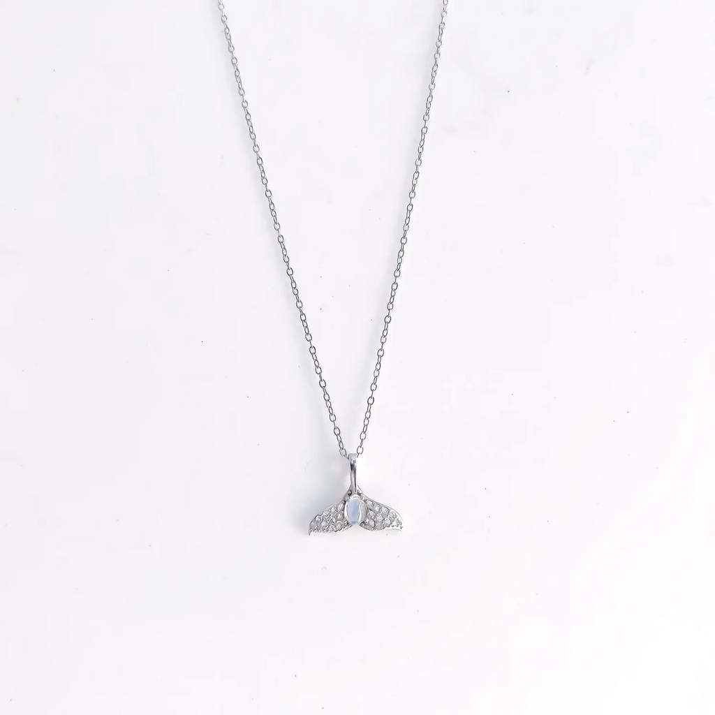 Sterling silver mermaid tail pendant, with a blue moon stone in the center and accent gems.