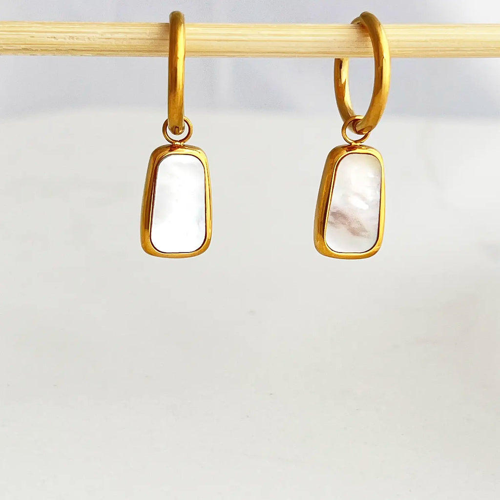 18k gold plated rectangular framed pearl drop earrings. The color of the pearl stone is white with a slight pink hue.