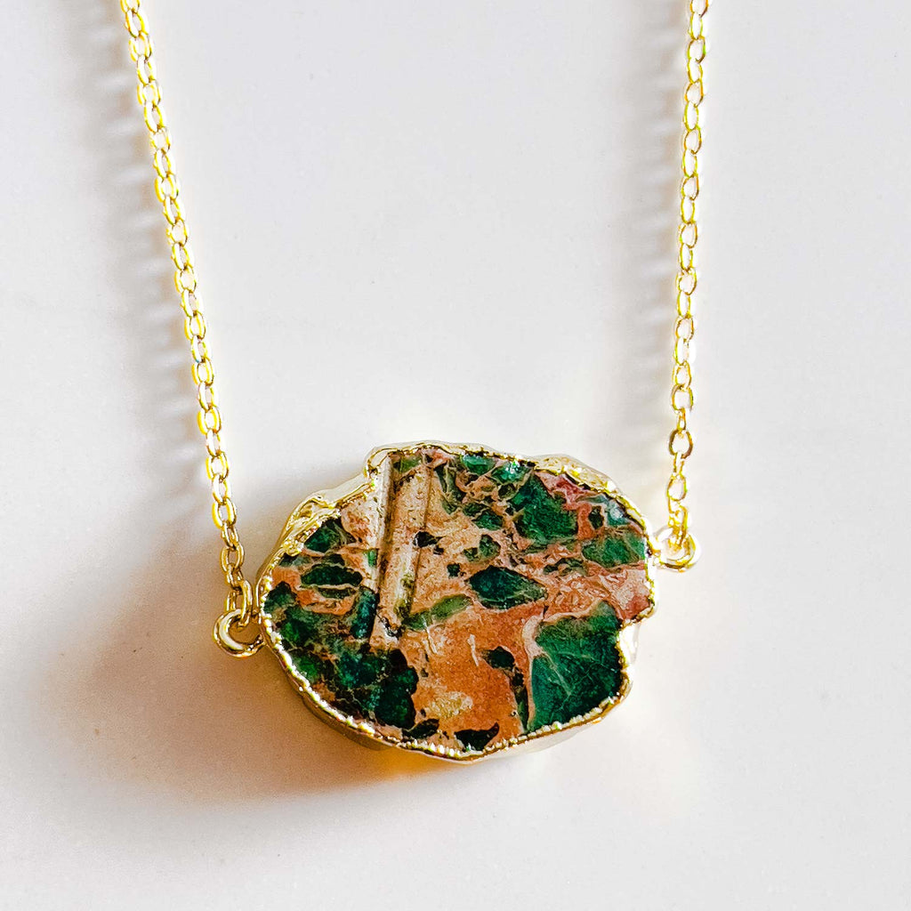 18k gold plated pendant necklace, pendant is a turquoise stone with gold/yellow accent in the stone similar to ocean and land rock meeting. Every necklace is unique.
