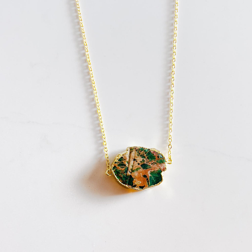 18k gold plated pendant necklace, pendant is a turquoise stone with gold/yellow accent in the stone similar to ocean and land rock meeting. Every necklace is unique