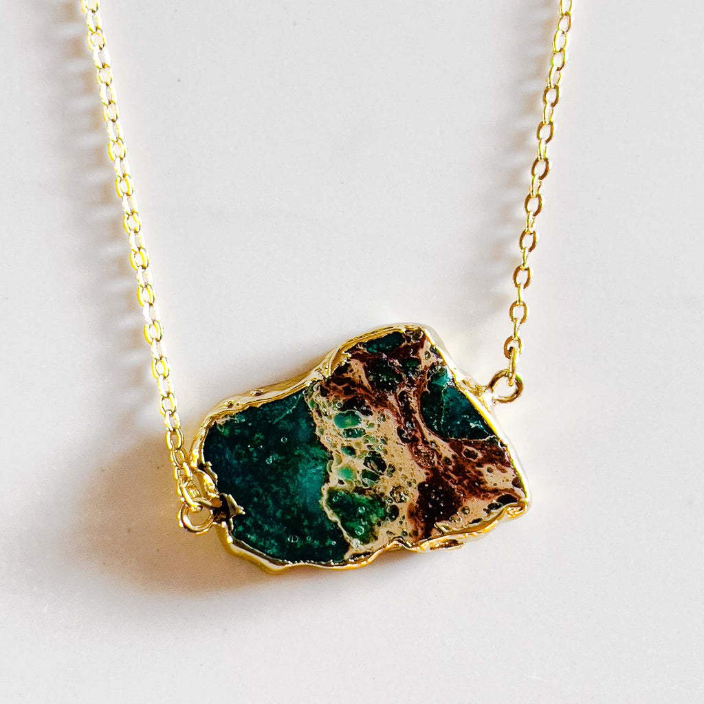 18k gold plated pendant necklace, pendant is a turquoise stone with gold/yellow accent in the stone similar to ocean and land rock meeting.