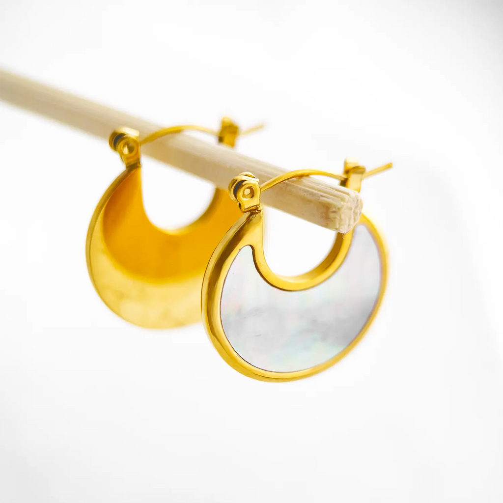 displayed 18k gold plated crescent moon earrings, the inside of the crescent moon is malachite and natural shell, color white with the gold plated rim