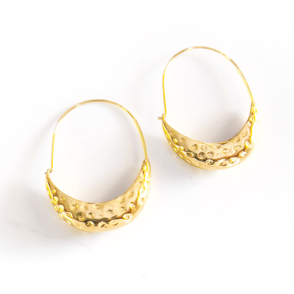 18k gold plated hammered hoop earrings. Thin hoop on top and thicker canoe-shaped and textured bottom half.