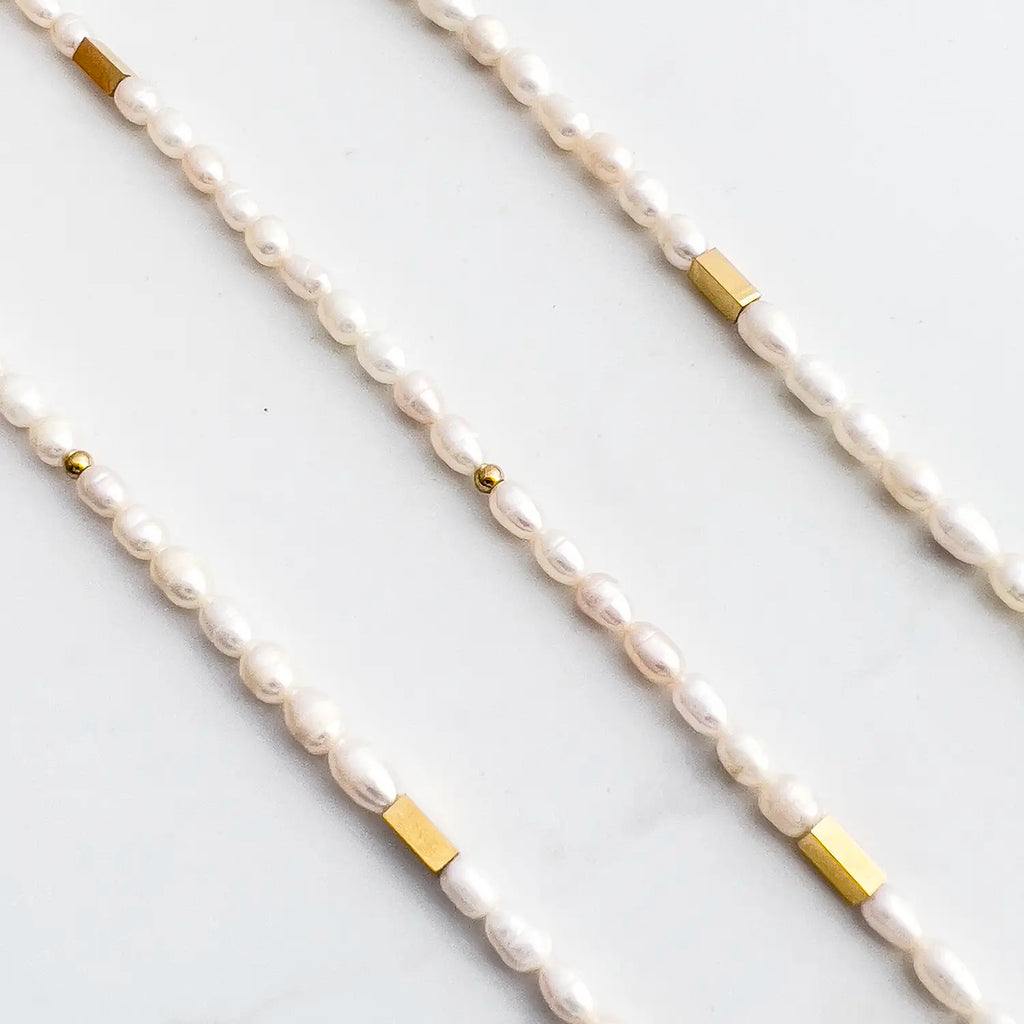 small freshwater pearl choker necklace with small 18k gold plated accent beads along the chain.