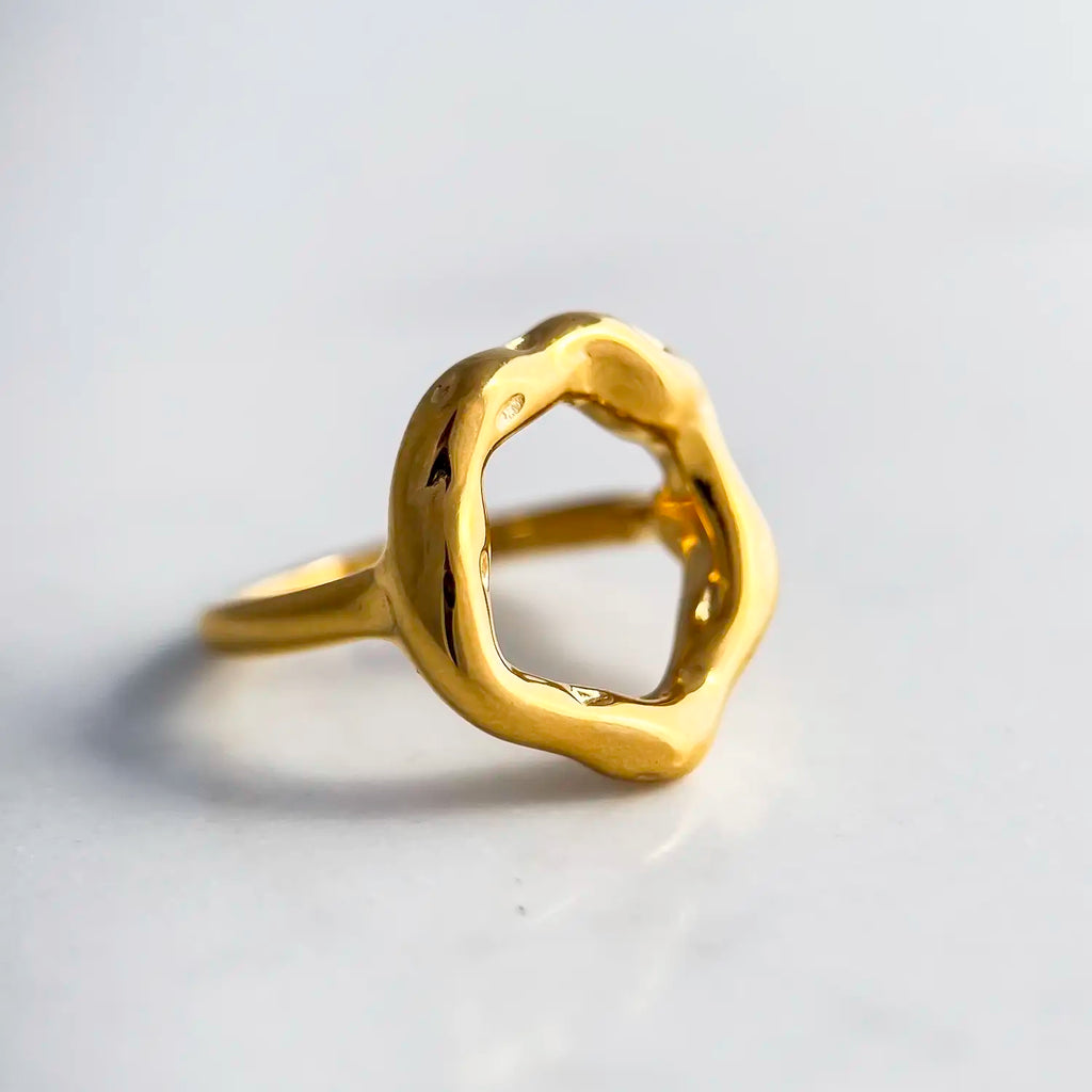 18k gold plated ring with slightly mishapen circle. (abstract "O" on top)