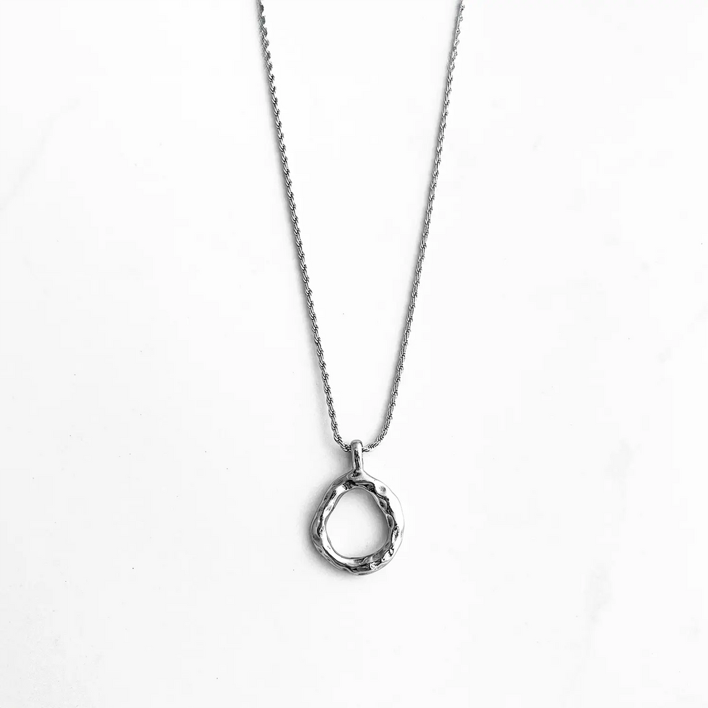 Silver color stainless steel pendant necklace, pendant is a slightly mishapen circle. (abstract "O" pendant)