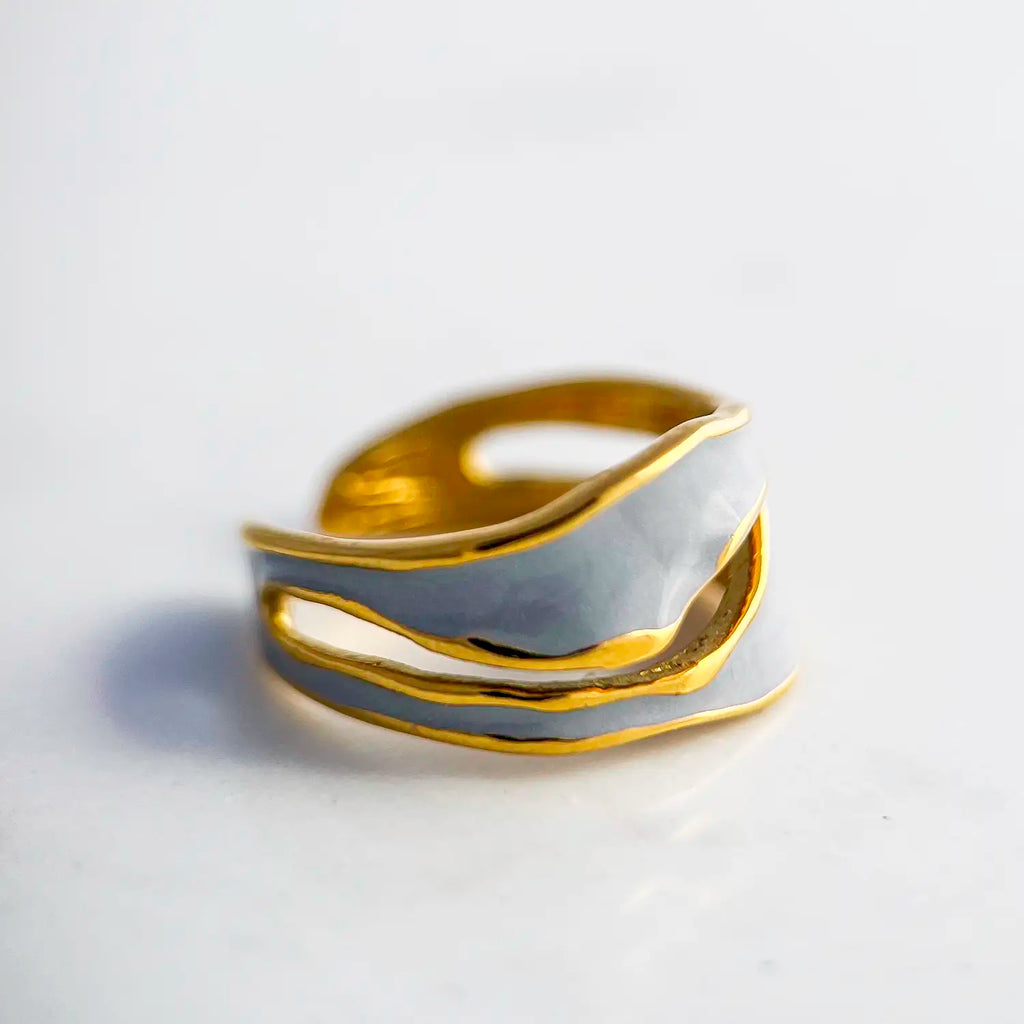 18k gold plated enamel ring. Adjustable ring with wavy structure, color light blue.