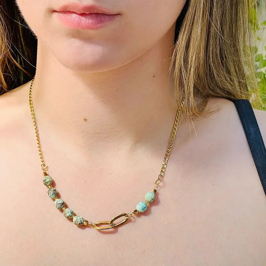 Girl wearinig 18k gold plated chain and stone necklace with turquoise stone beads.